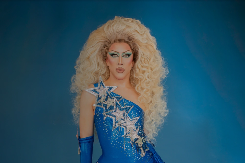Drag Bingo hosts on stage in the Christmas Lounge